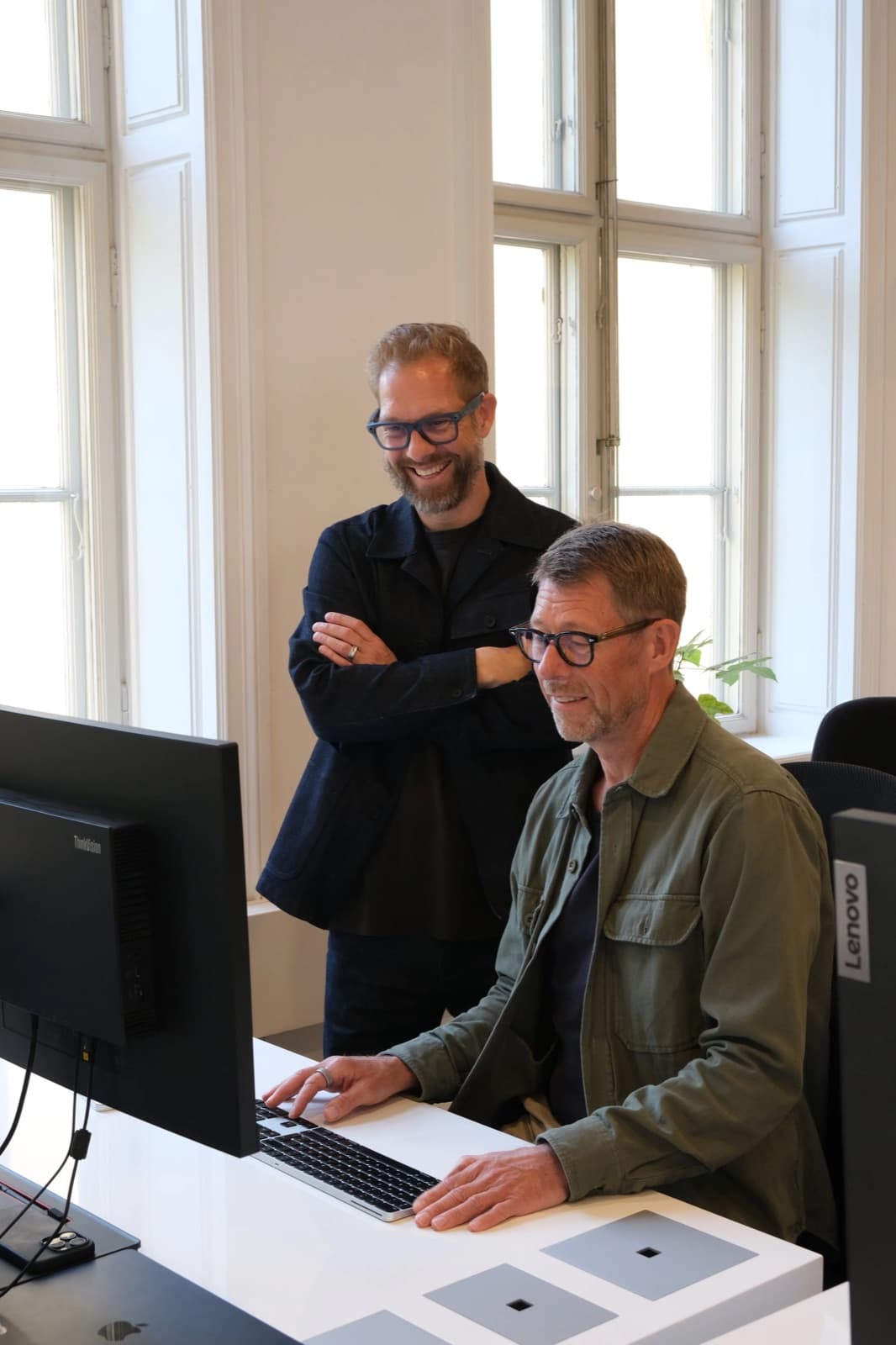 To rådgivere ser på en computer i et kontormiljø
